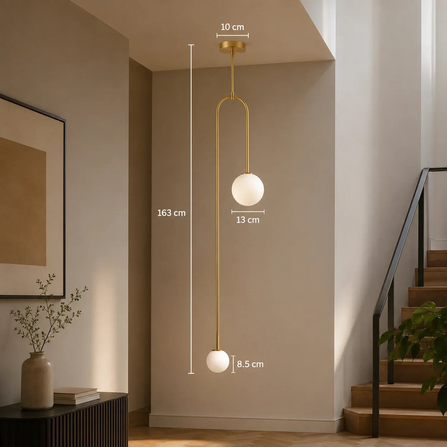 Modern double globe pendant light in gold finish with dimensions shown, featuring two spherical glass shades suspended in a minimalist interior hallway.