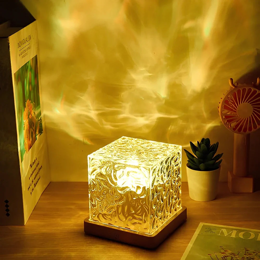 Cube table lamp casting warm patterns beside books