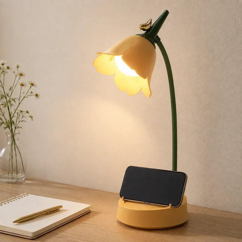 Yellow flower lamp base holding a phone