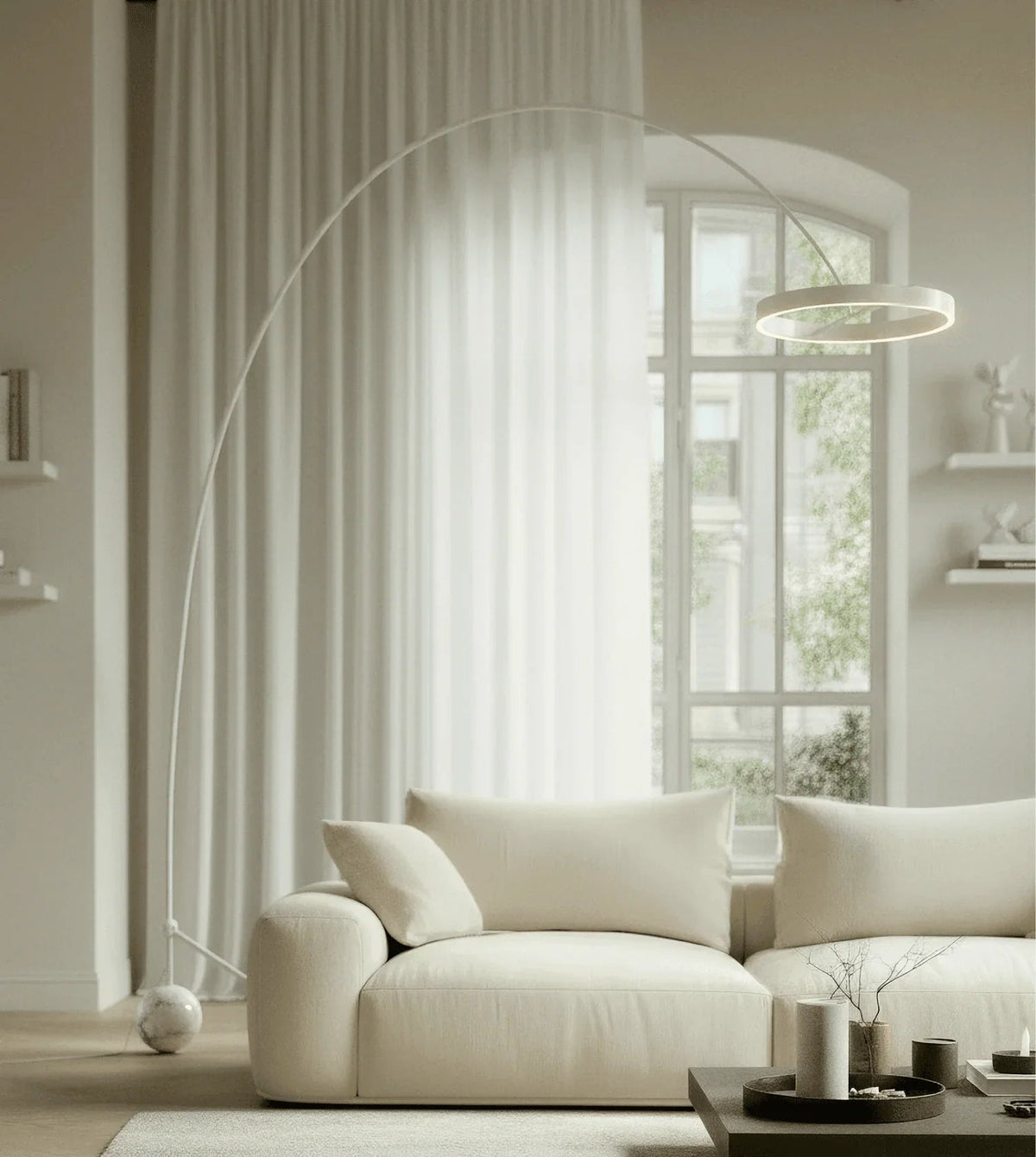 White arc floor lamp beside a sofa