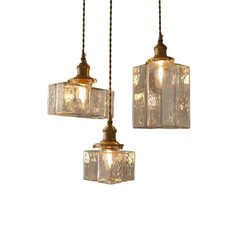 Three textured glass pendants against a white background