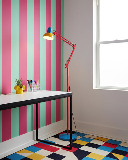 Memphis-style floor lamp beside a pink and green wall