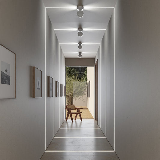 Adjustable LED ceiling spotlights creating light patterns in a hallway