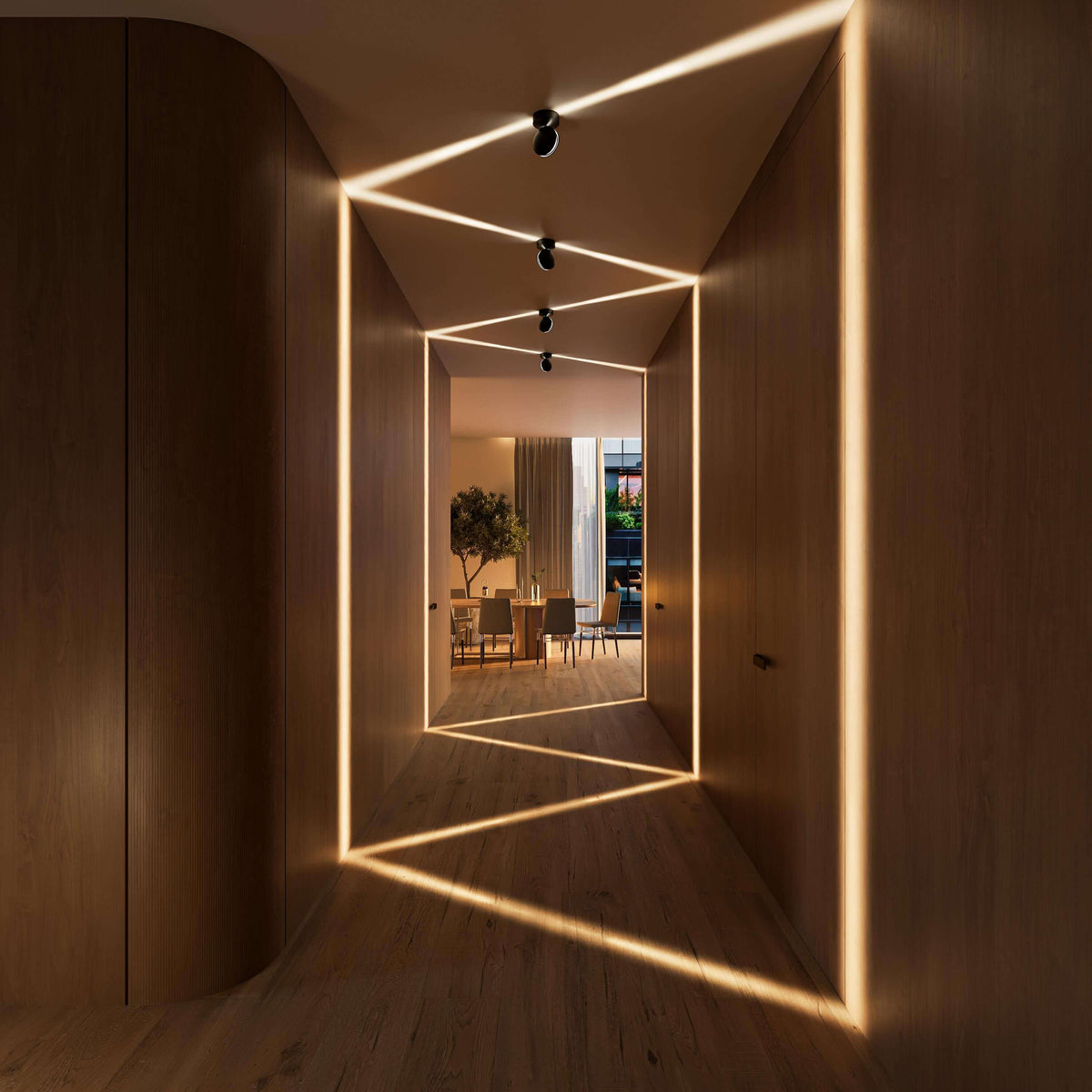 Black rotating-disc LED ceiling spotlights directing light in a hallway