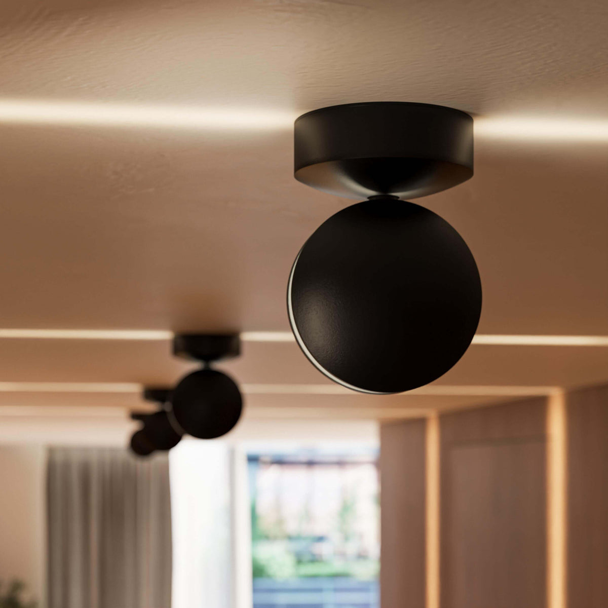 Close-up of a black rotating-disc LED ceiling spotlight