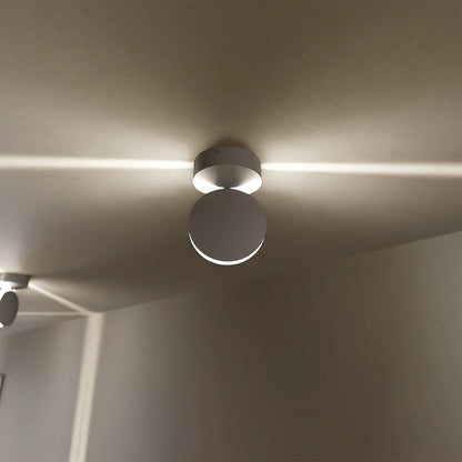White rotating-disc LED ceiling spotlights in a hallway