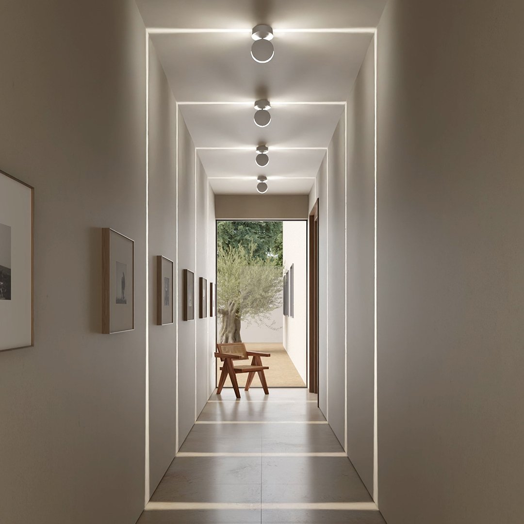 White adjustable LED ceiling spotlights along a hallway