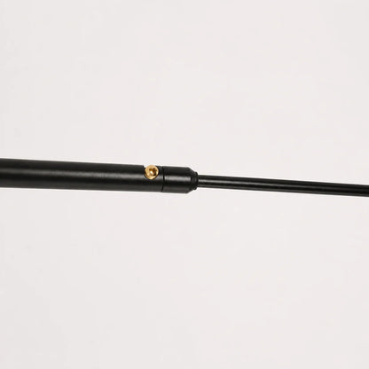 Close-up of the adjustable black metal swing arm of the wall lamp, showing the brass adjustment screw mechanism against a white background.