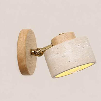 Adjustable wall light featuring a natural log wood base and a textured travertine spotlight head with a brass swivel joint for directional lighting.