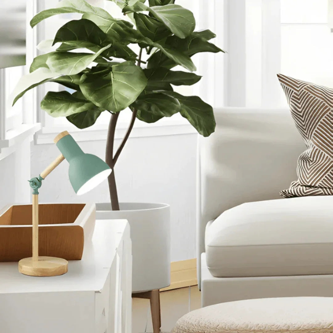 Mint green task lamp beside a sofa