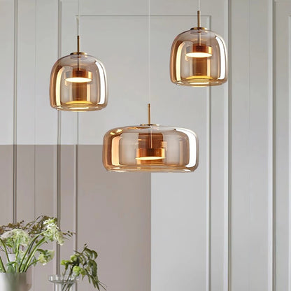 Three amber glass dome pendant lights above a dining table