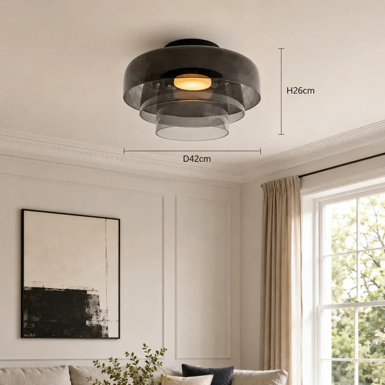 An Art Deco glass ceiling light with tiered smoky grey glass shades, mounted in a living room. Dimensions are marked as H26cm and D42cm.
