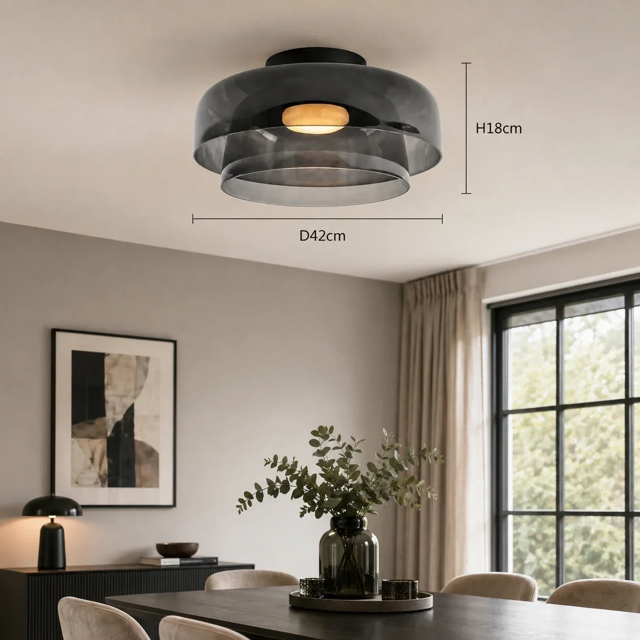Art Deco glass ceiling light with a smoky grey shade and warm glow, surface-mounted in a dining room. Dimensions shown: D42cm by H18cm.