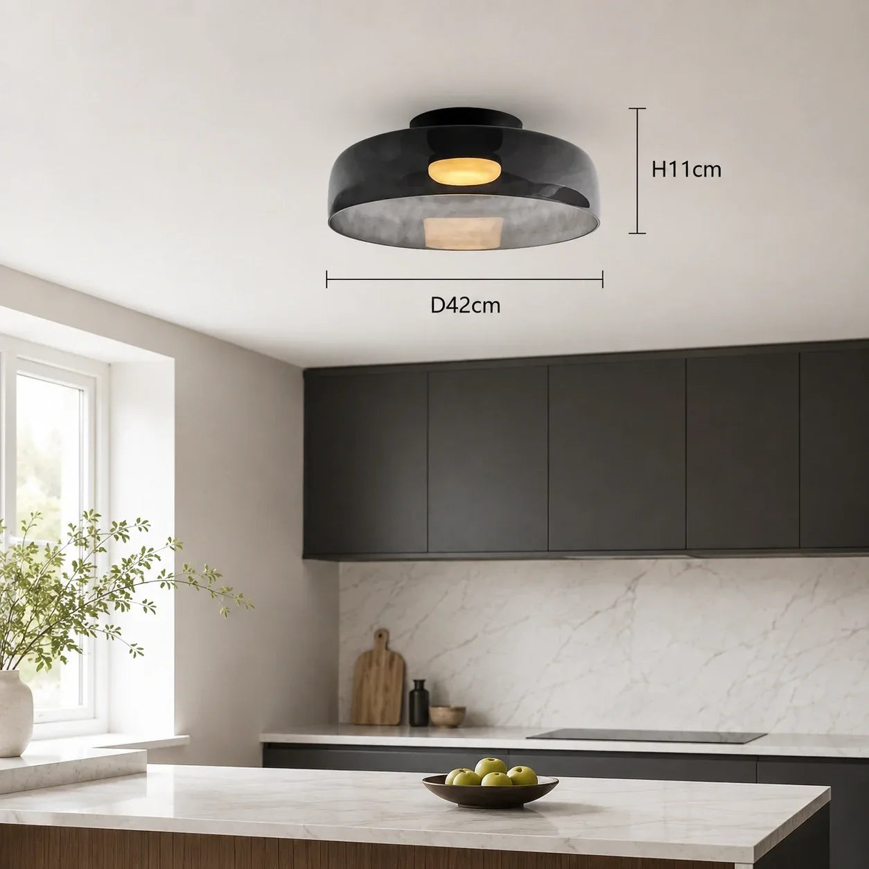 A smoke grey Art Deco glass ceiling light with a warm glow, showing H11cm and D42cm dimensions, mounted on a modern kitchen ceiling.