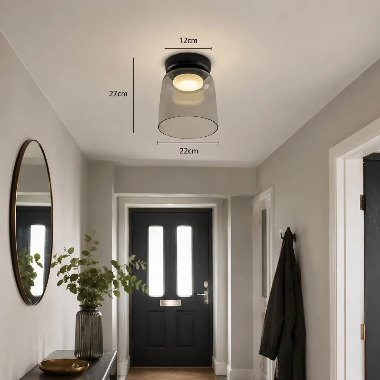 Art Deco glass ceiling light with a grey shade and black mount, illuminated with warm light in a modern hallway, showing dimensions of 27cm by 22cm.