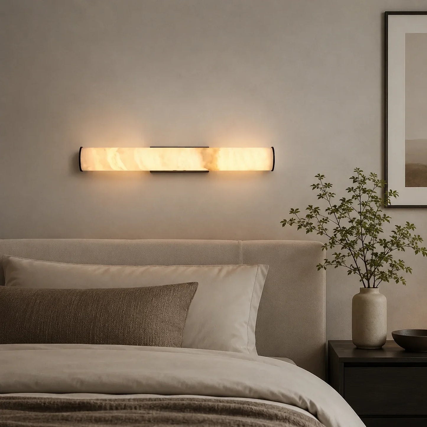 An Art Deco LED wall light with a glowing simulated marble shade mounted on a neutral wall above a bed in a modern, minimalist bedroom.