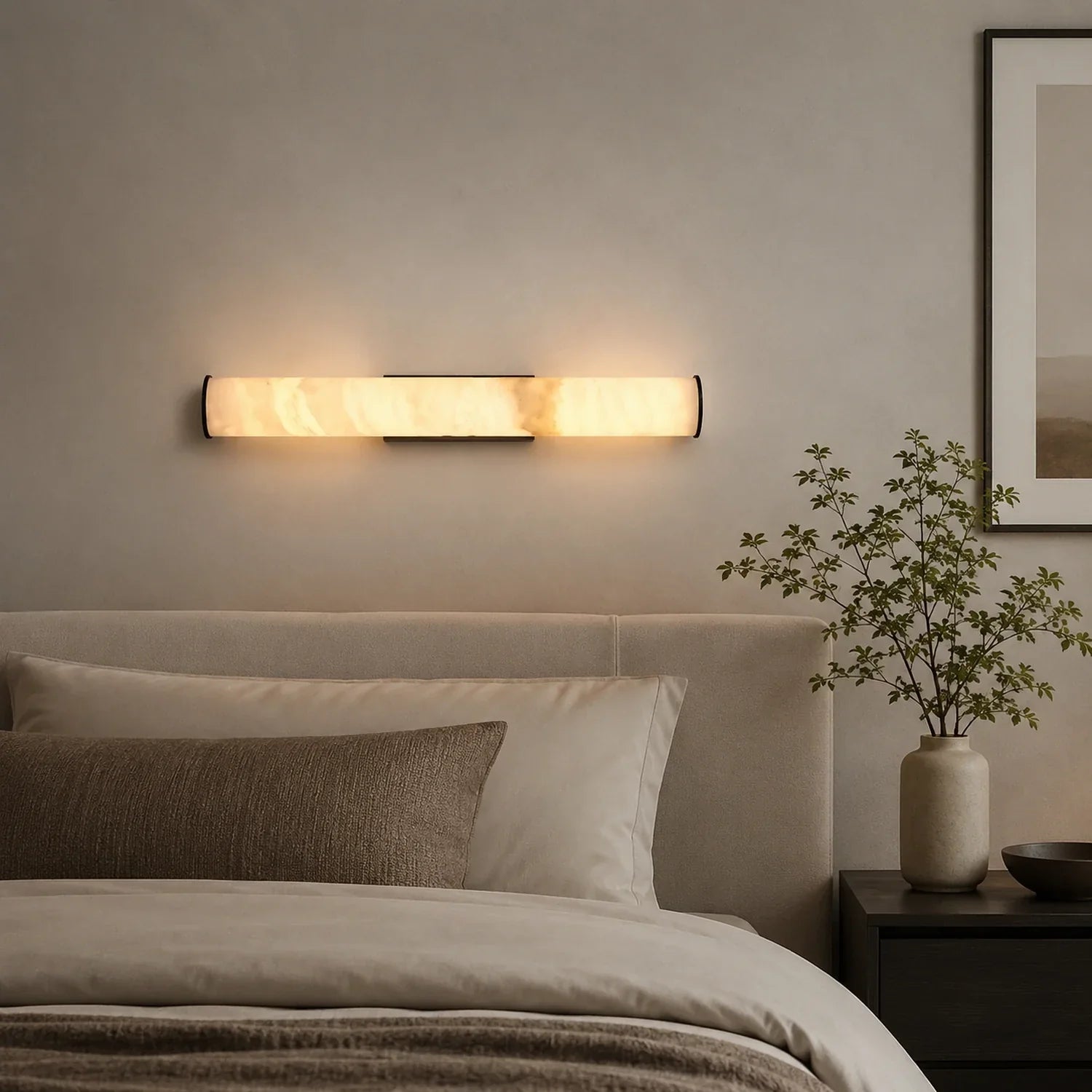 An Art Deco LED wall light with a glowing simulated marble shade mounted on a neutral wall above a bed in a modern, minimalist bedroom.