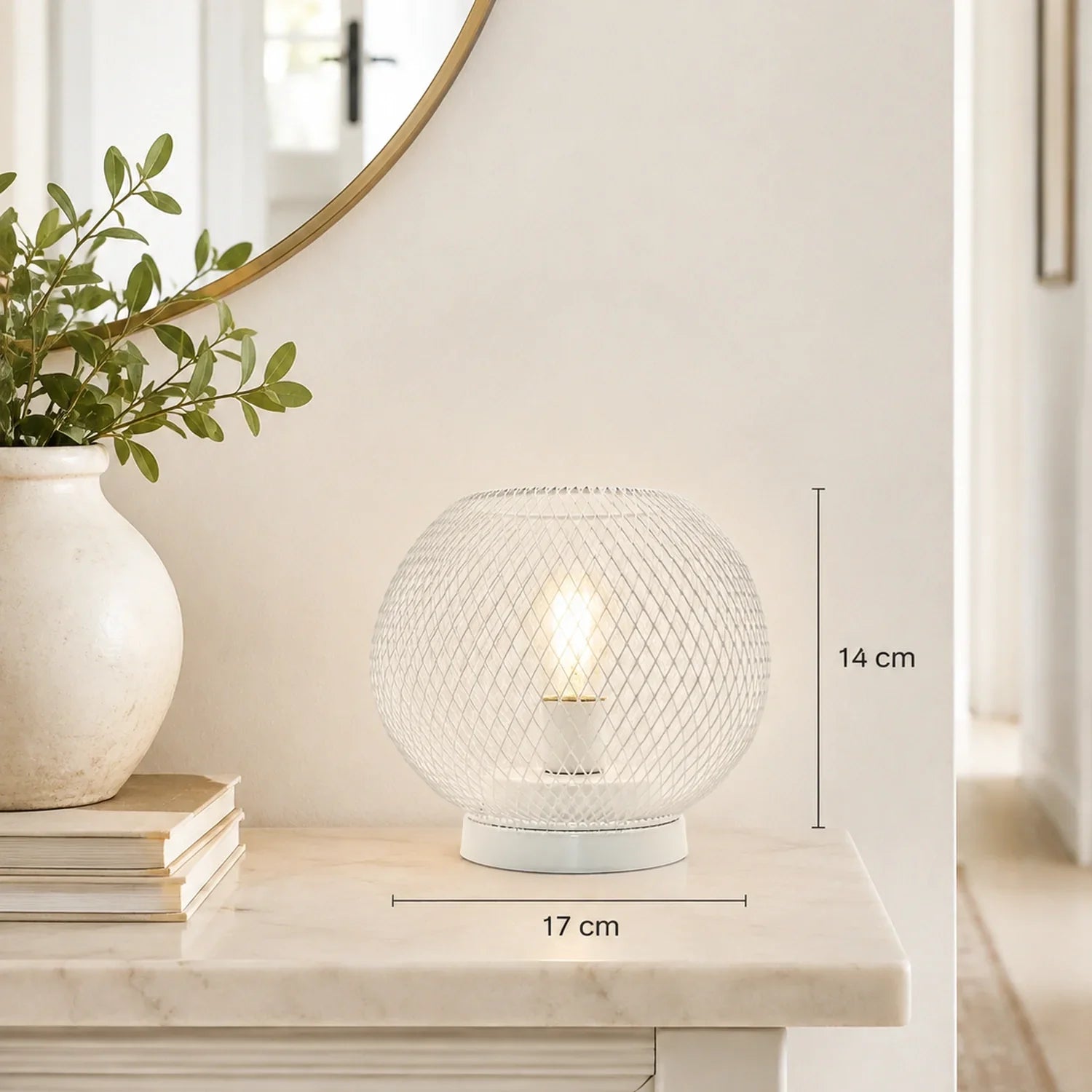 White battery-operated table lamp with a round mesh design, measuring 14 cm in height and 17 cm in width, displayed on a marble surface for ambient light.
