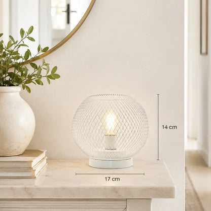White battery-operated table lamp with a round mesh design, measuring 14 cm in height and 17 cm in width, displayed on a marble surface for ambient light.
