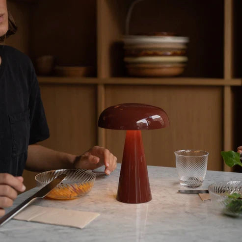 Red battery table lamp in a dining setting