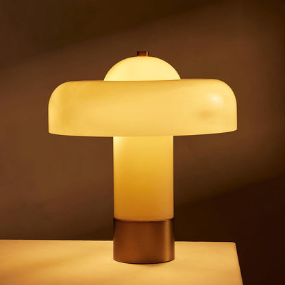 Beige glass column lamp glowing warmly