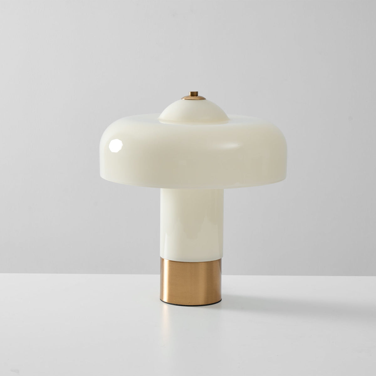 Beige glass lamp against a pale wall