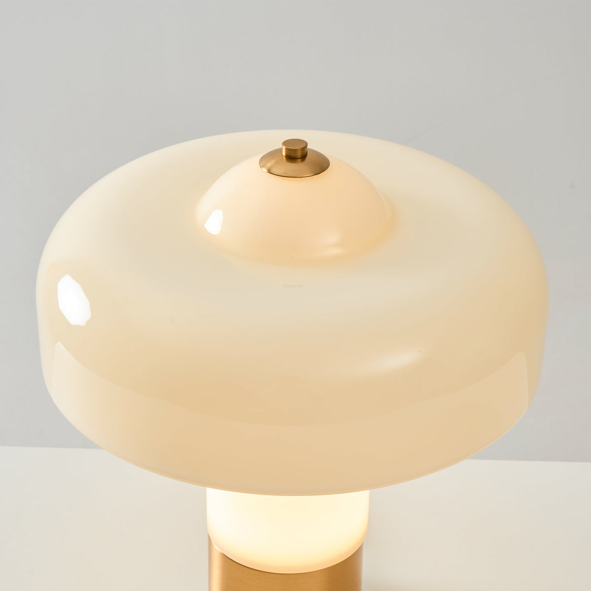 Top view of glossy beige shade and metallic finial