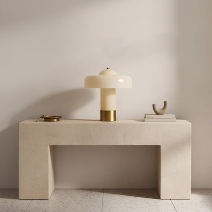 Glass column table lamp on a console table