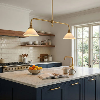 Warmly lit brass pendant above a kitchen island