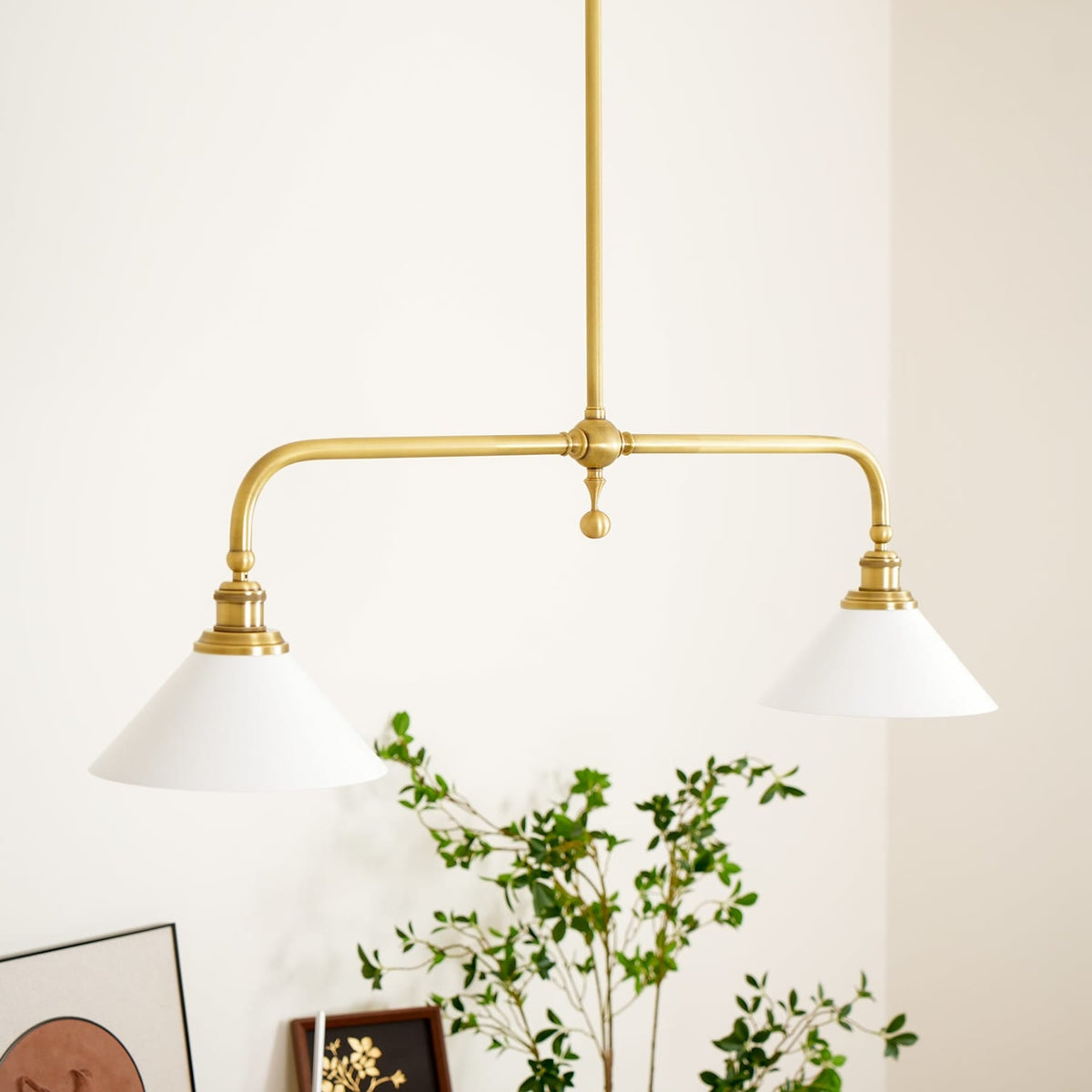 White ceramic pendant shades above a cabinet