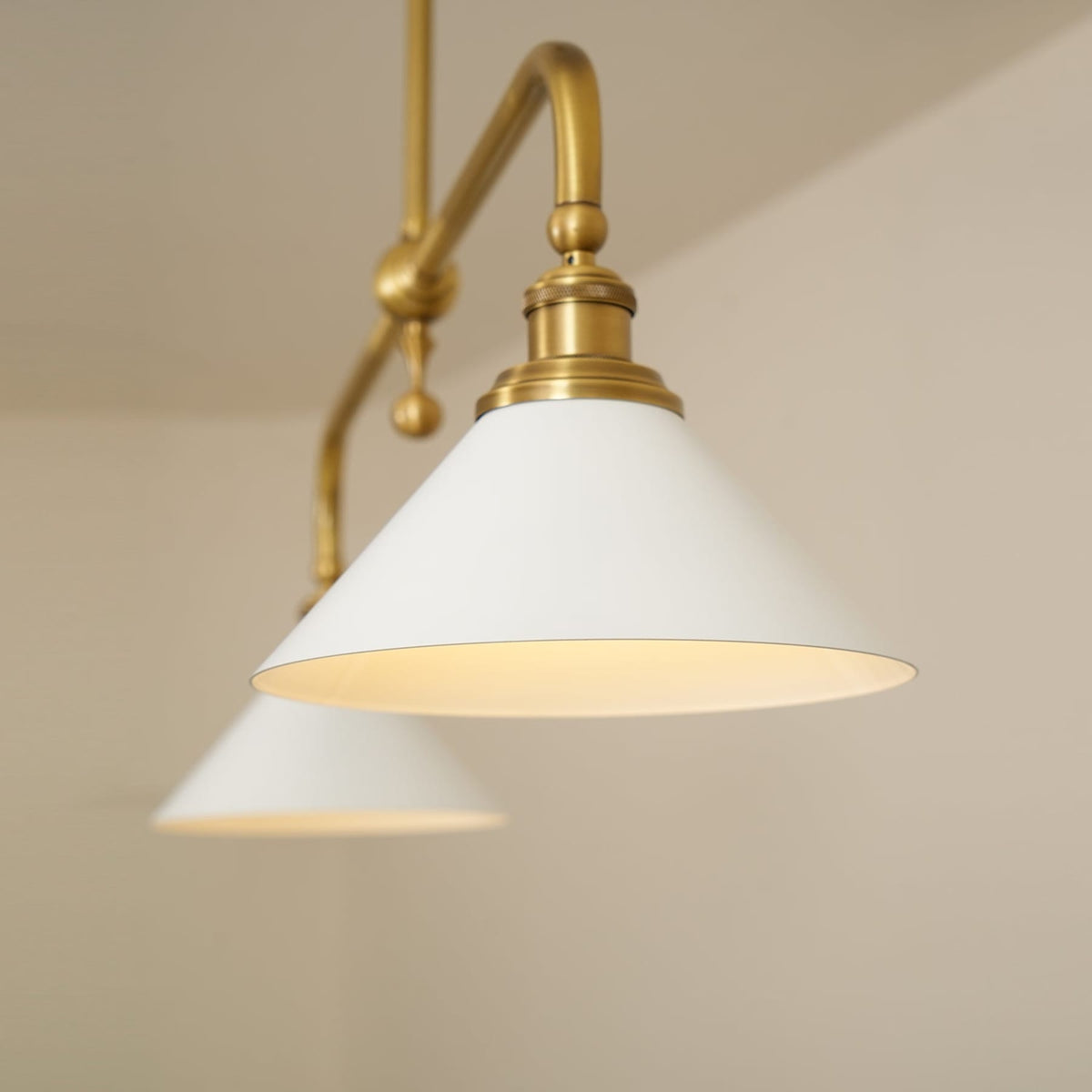 Close-up of illuminated ceramic shade and brass arm