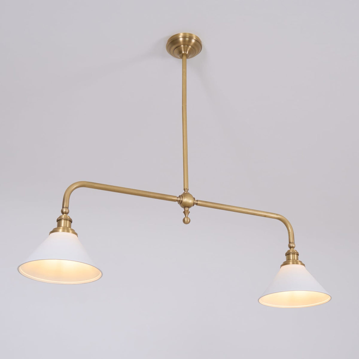 Illuminated ceramic shades on a brass pendant