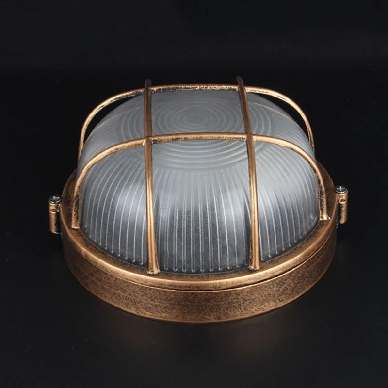 Bronze round outdoor bulkhead light with frosted glass and protective cage
