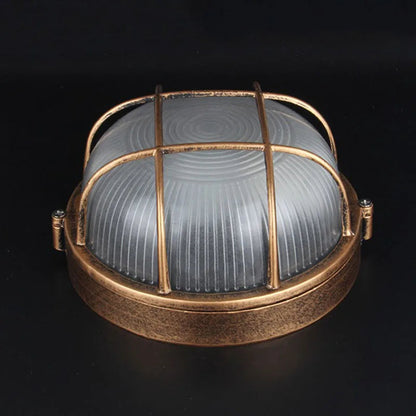 Bronze round outdoor bulkhead light with frosted glass and protective cage