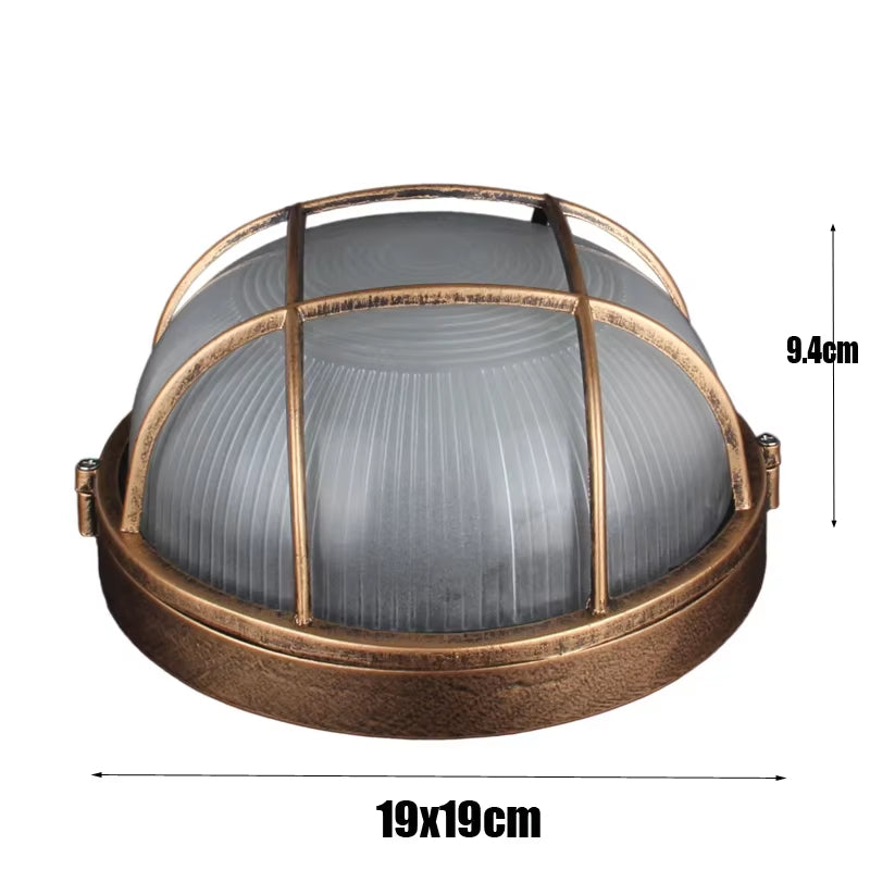 Bronze round outdoor bulkhead light with frosted glass and protective cage