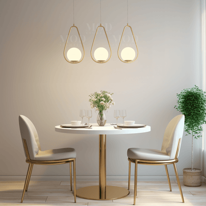 Brushed gold teardrop cage pendant lights above a round dining table