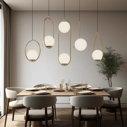 Glass globe cage pendant lights in assorted frame styles above a dining table