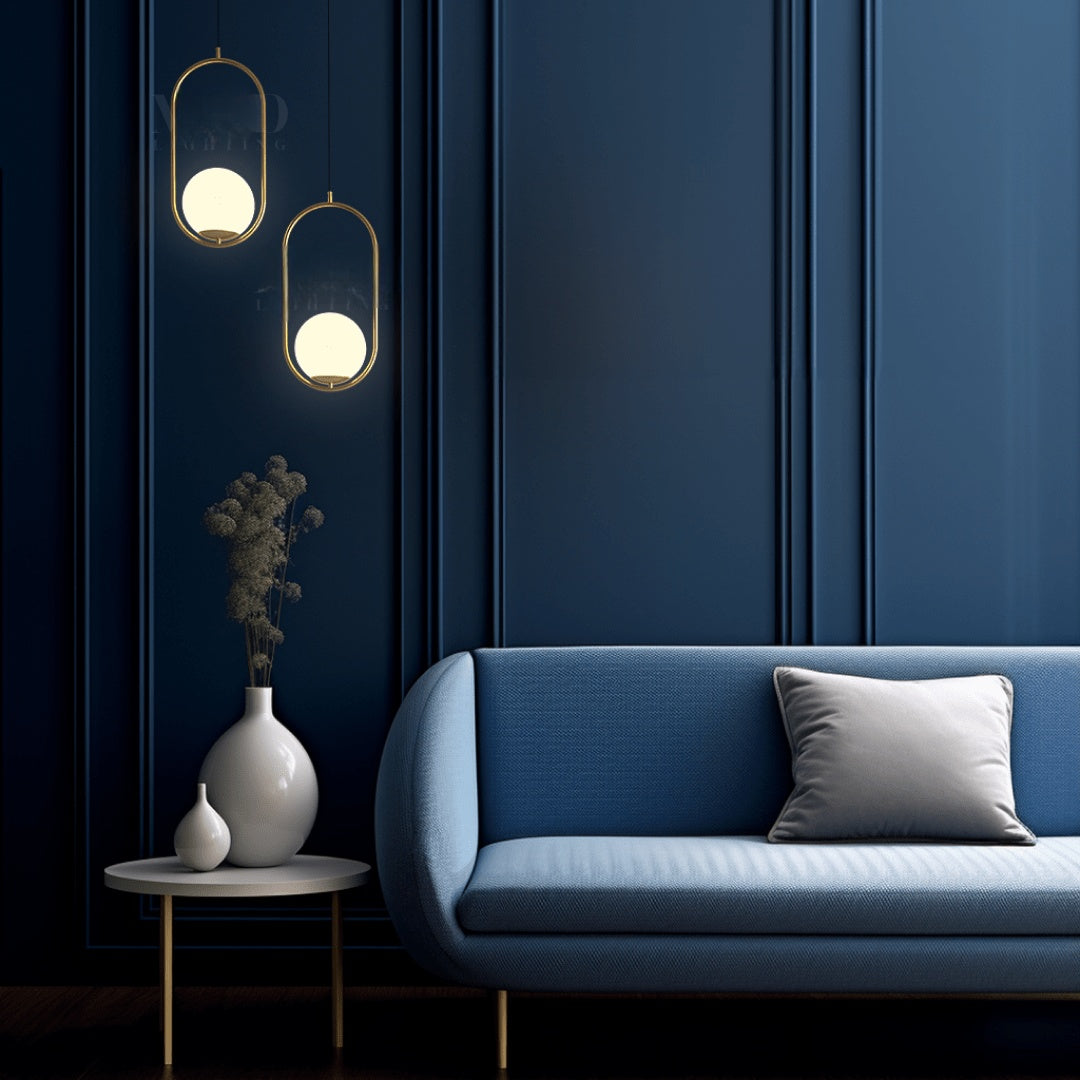 Brushed gold oval cage pendant lights beside a sofa