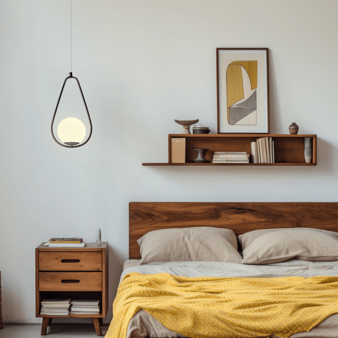Black teardrop cage pendant light above a bed