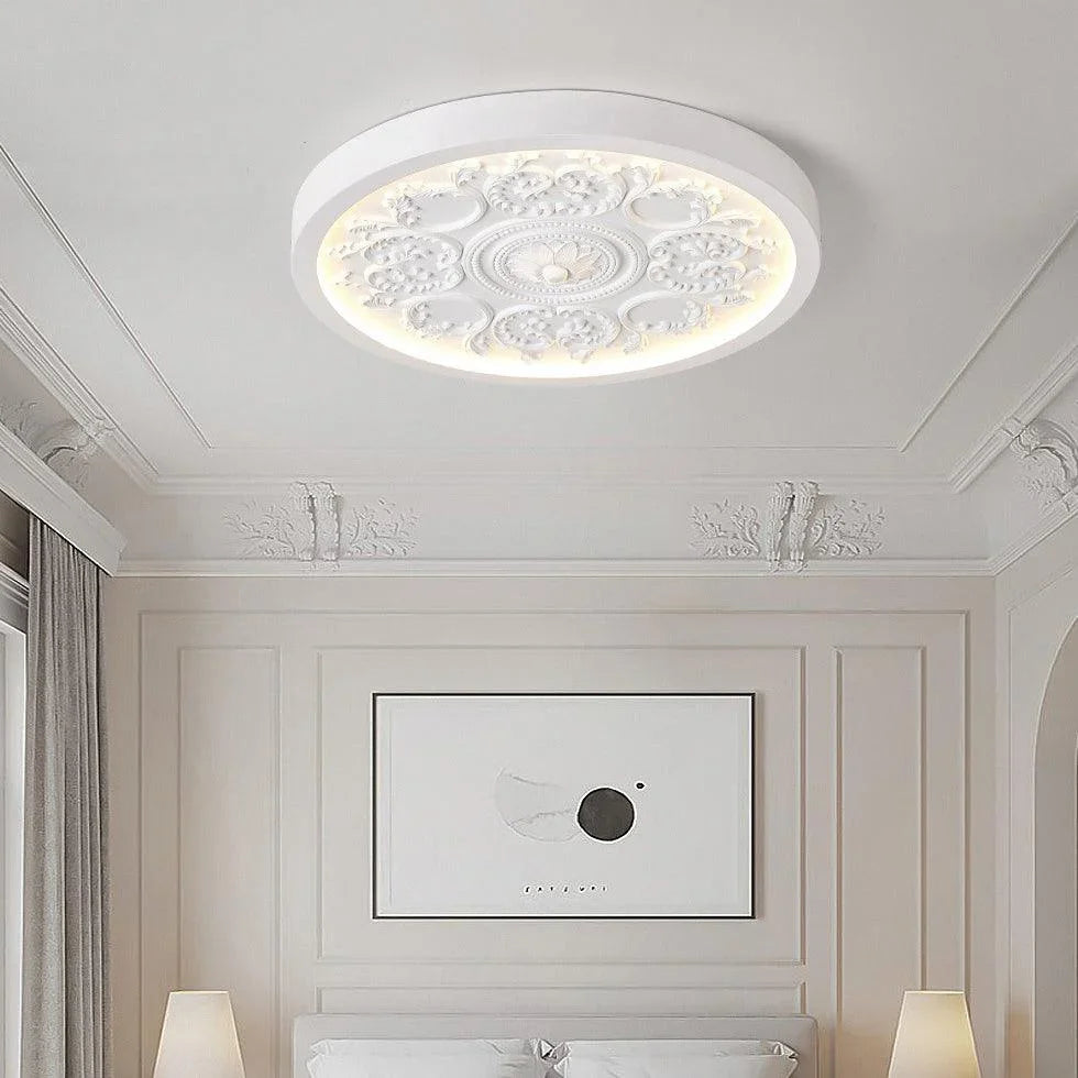 White carved rosette flush ceiling light in a bedroom