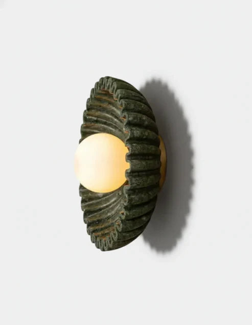 Side view of ceramic flower sconce with opal globe