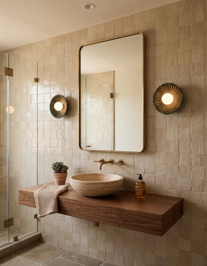 Flower wall sconces beside a bathroom mirror