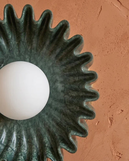 Green pleated ceramic wall sconce close-up