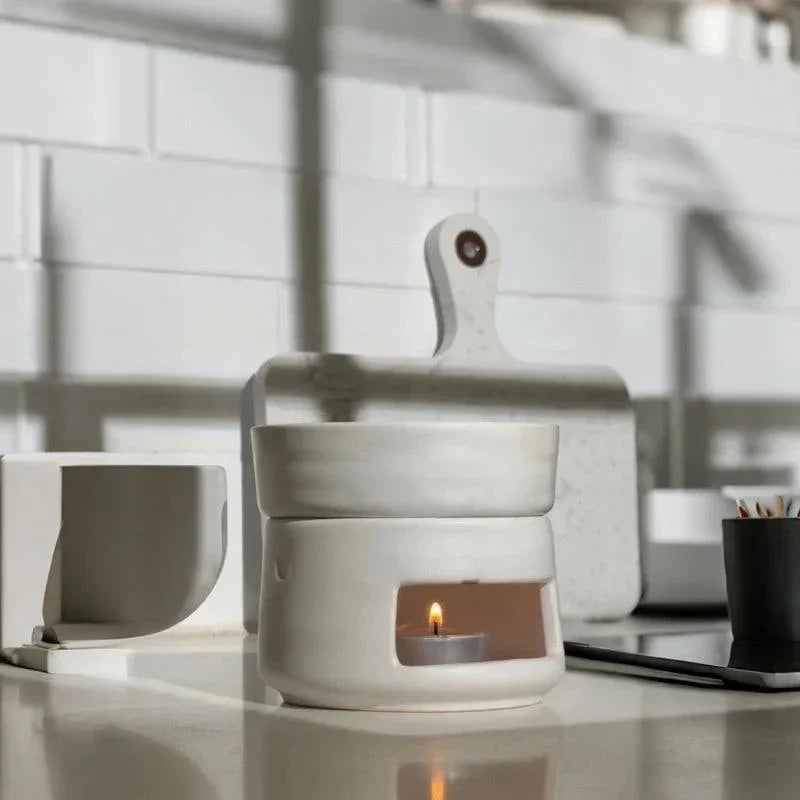 White ceramic fragrance burner with a lit tea light