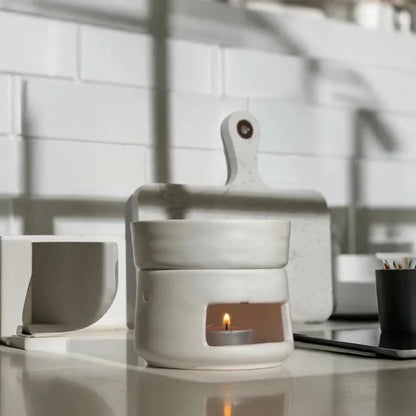 White ceramic fragrance burner with a lit tea light