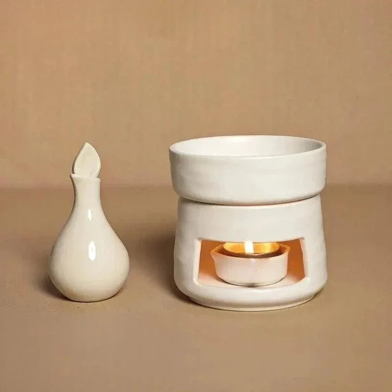 White ceramic wax melt burner with a lit tea light