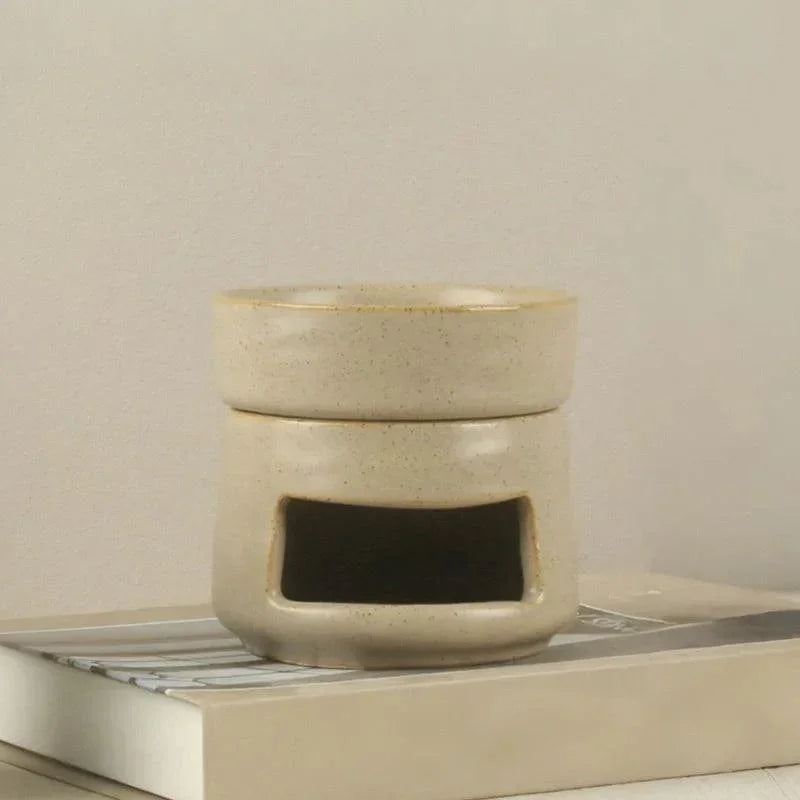 Glazed cream ceramic oil burner close-up