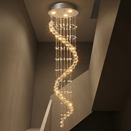 Chrome crystal spiral chandelier illuminated in a stairwell