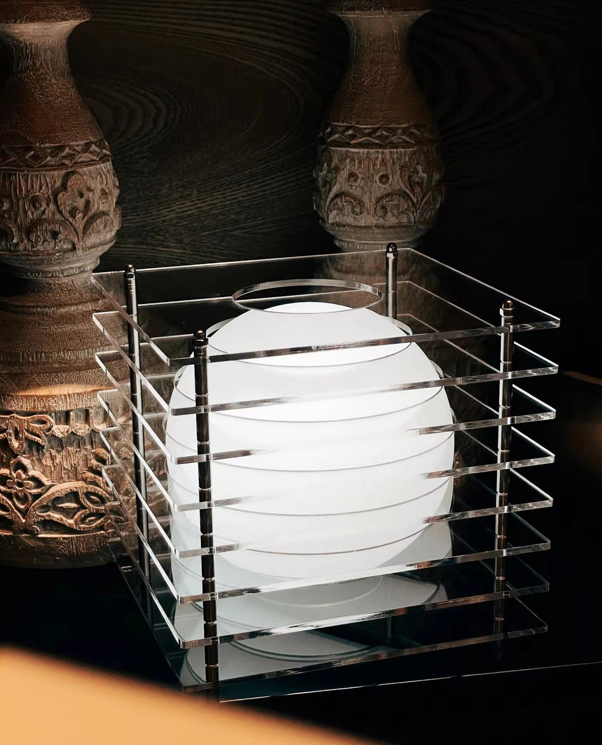 Clear acrylic cube rechargeable LED table lamp illuminated indoors