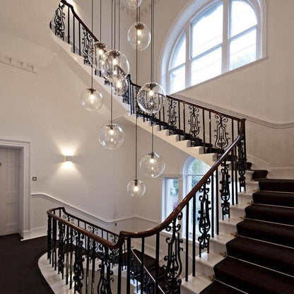 Clear glass globe pendant lights in a stairwell